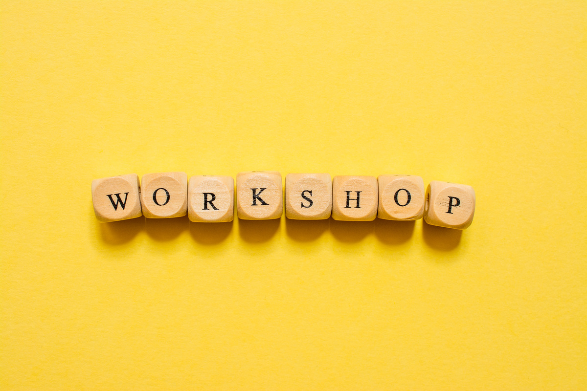 the word Workshop, text made with dice on yellow background